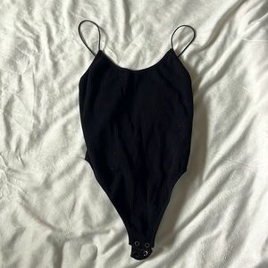 Black bodysuit, worn, very stretchy, thong type bodysuit.